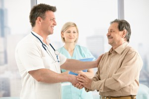 Doctor shaking hands with senior patient